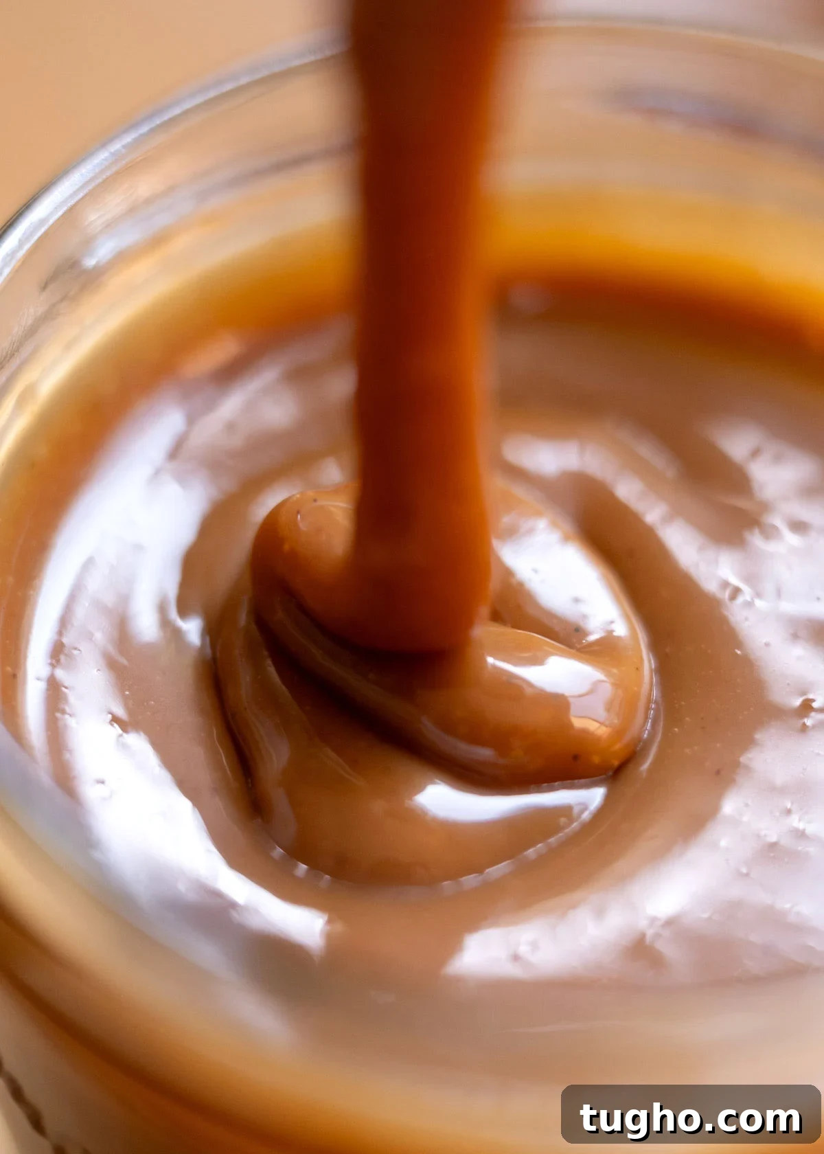 Cajeta: Authentic Mexican Goat Milk Caramel Recipe 8 cajeta poured into a jar, showing ribbons
