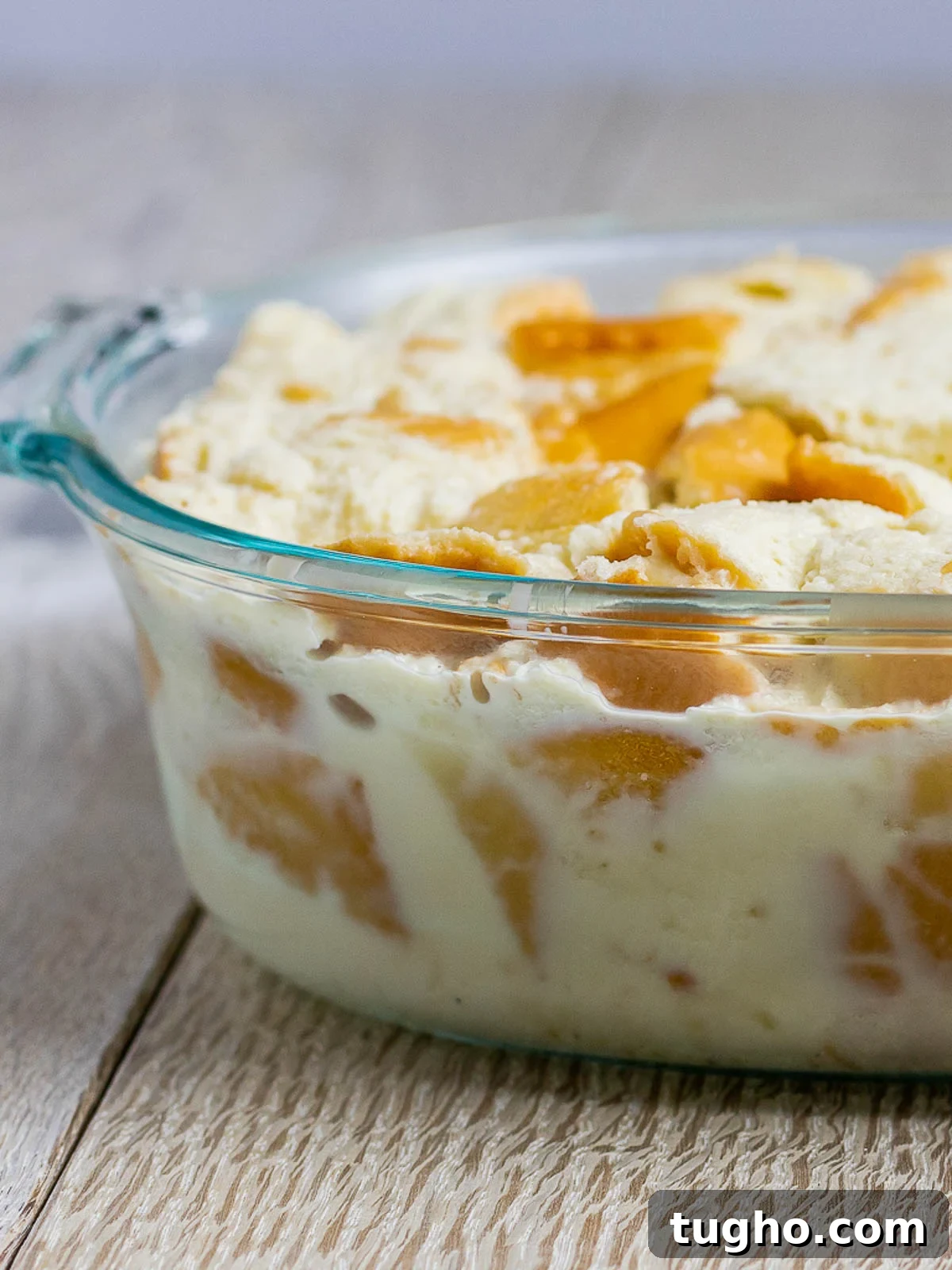 Bread cubes soaking in custard mixture.