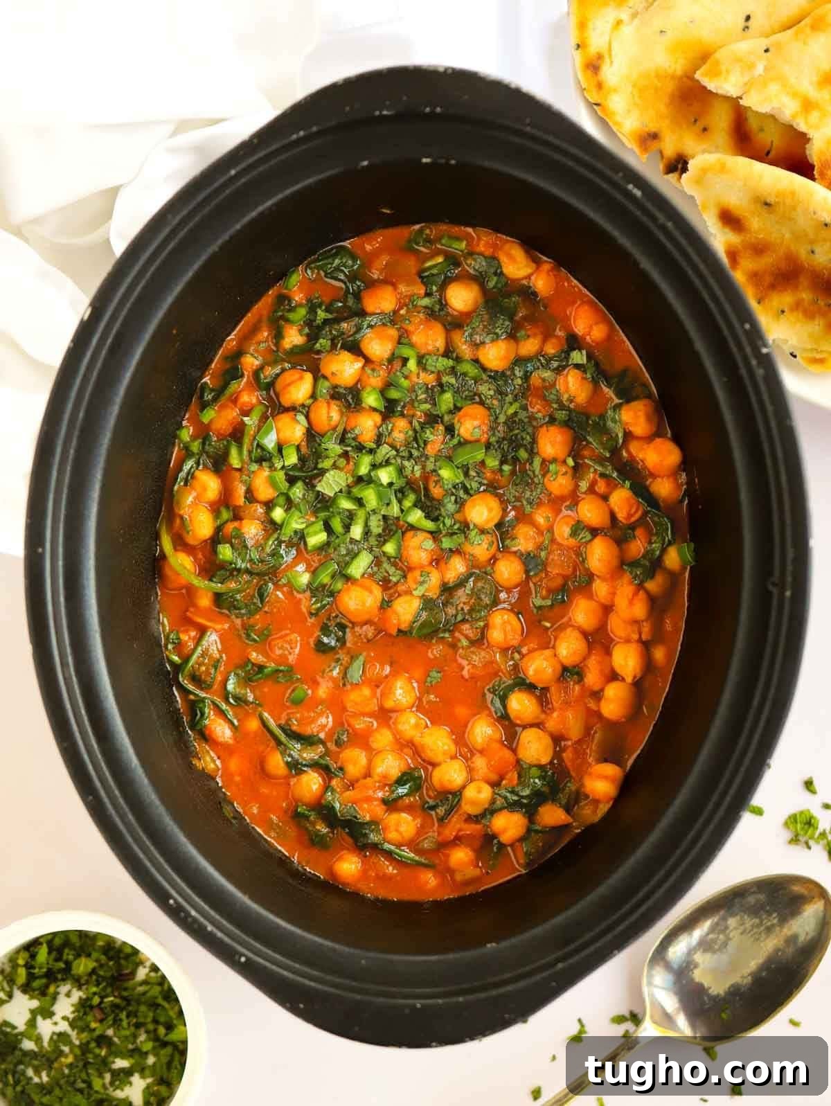 Slow Cooker Chana Saag: Chickpea Curry with Spinach 2 Slow cooker pan filled with chickpeas and spinach.