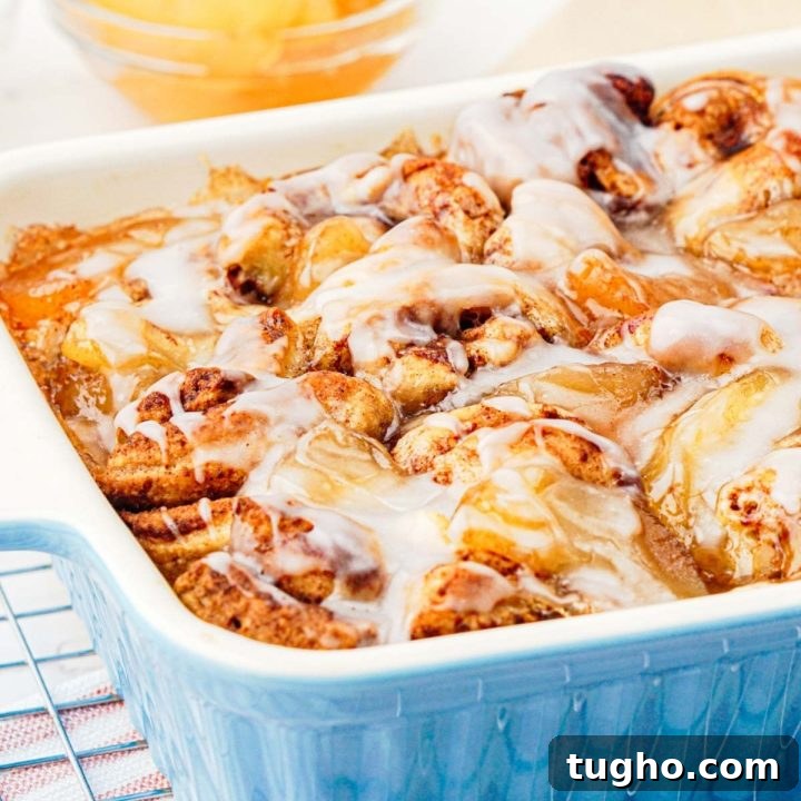 Homemade Apple Walnut Bars Recipe 11 Apple cinnamon roll bake in pan with glaze on top.