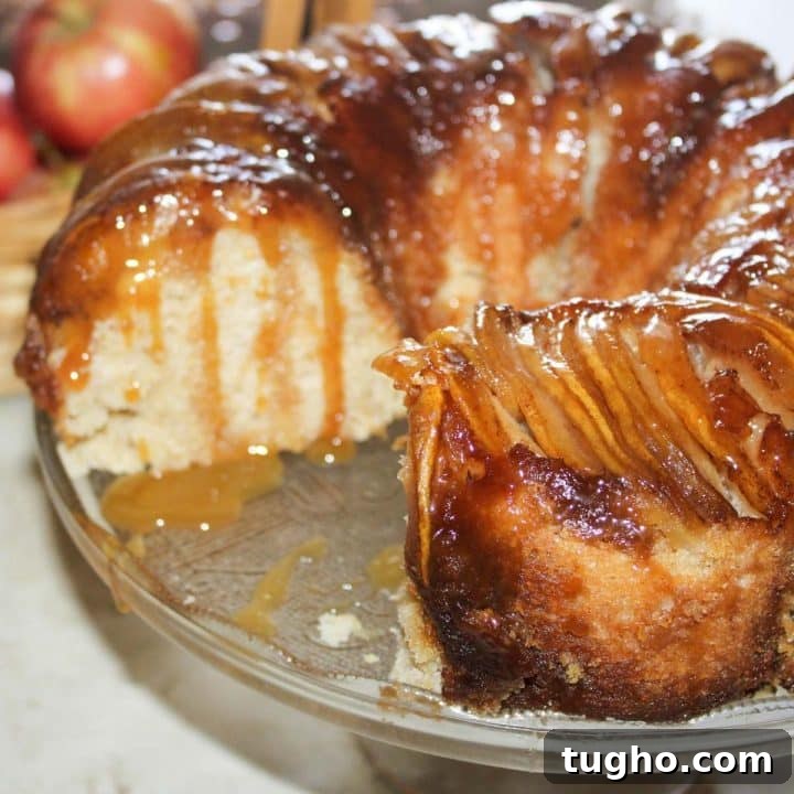 Homemade Apple Walnut Bars Recipe 12 Apple upside down bundt cake with a slice removed and caramel sauce dripping down the sides.
