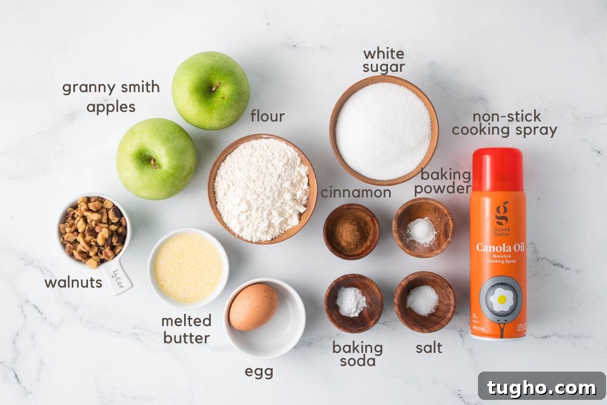 Homemade Apple Walnut Bars Recipe 3 Labeled ingredients for Apple Walnut Bars (two green apples, walnuts, flour, white sugar, melted butter, an egg, ground cinnamon, baking soda, baking powder, salt, and non-stick spray).