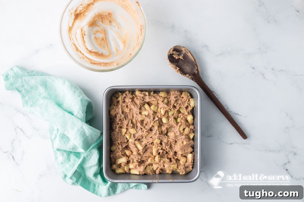 Homemade Apple Walnut Bars Recipe 7 Apple Walnut Bar batter spread in a prepared 9-inch by 9-inch baking pan.