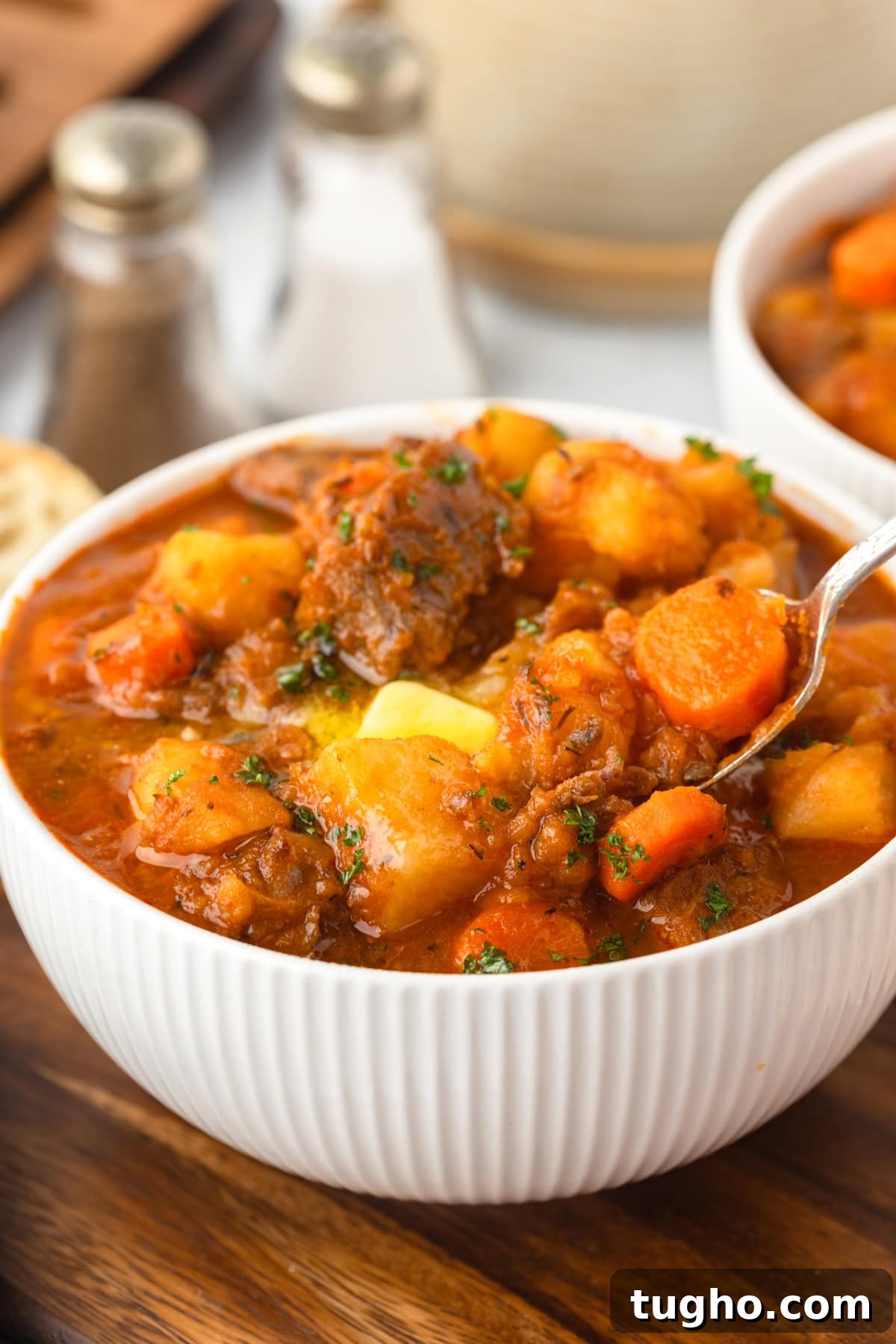 Beef Stew in a bowl with a spoon.
