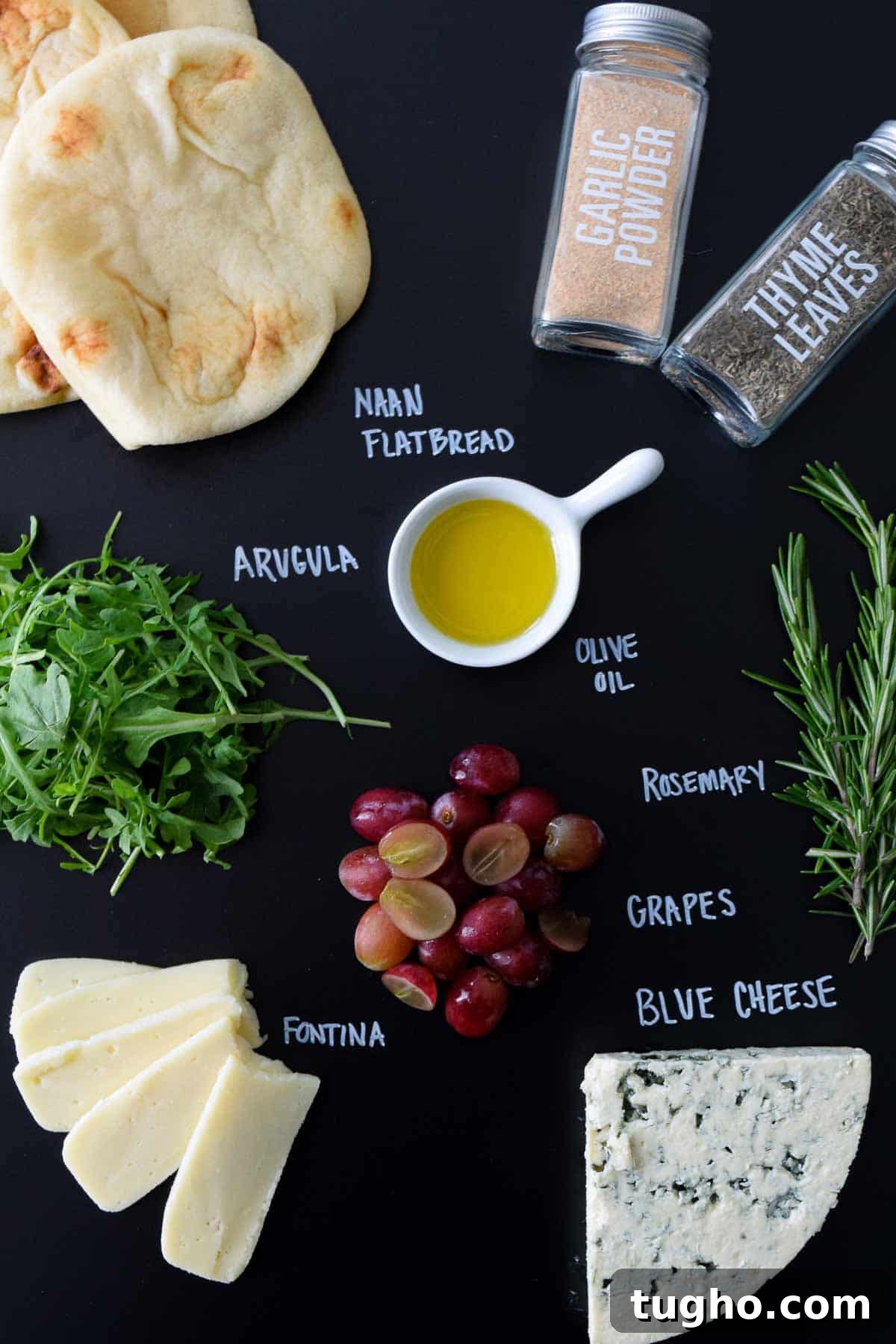 ingredients laid out on black chalkboard with names of each written in chalk
