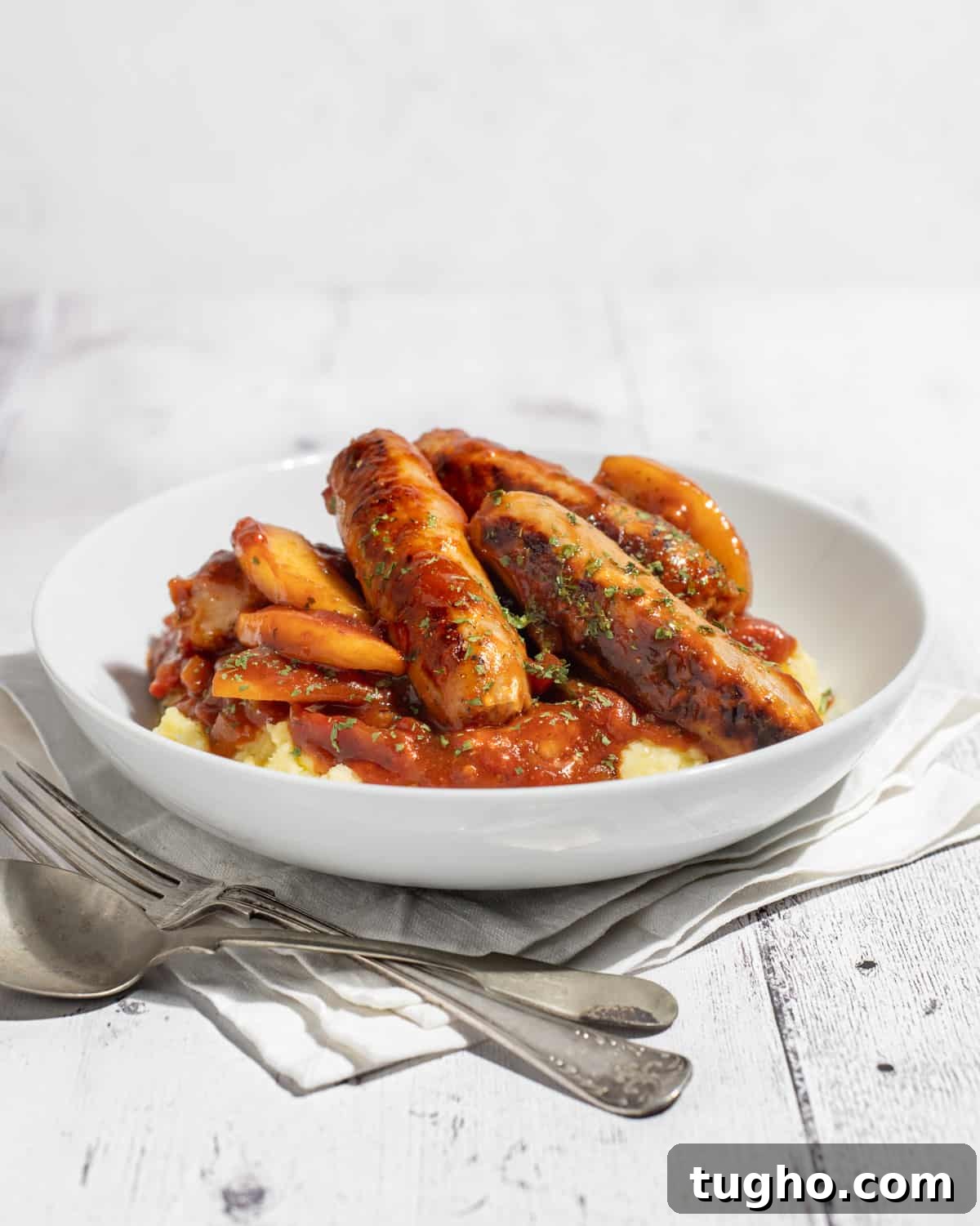 Devilled Sausages Recipe with Tangy Tomato Glaze 4 Devilled sausages on a bed of mashed potato.