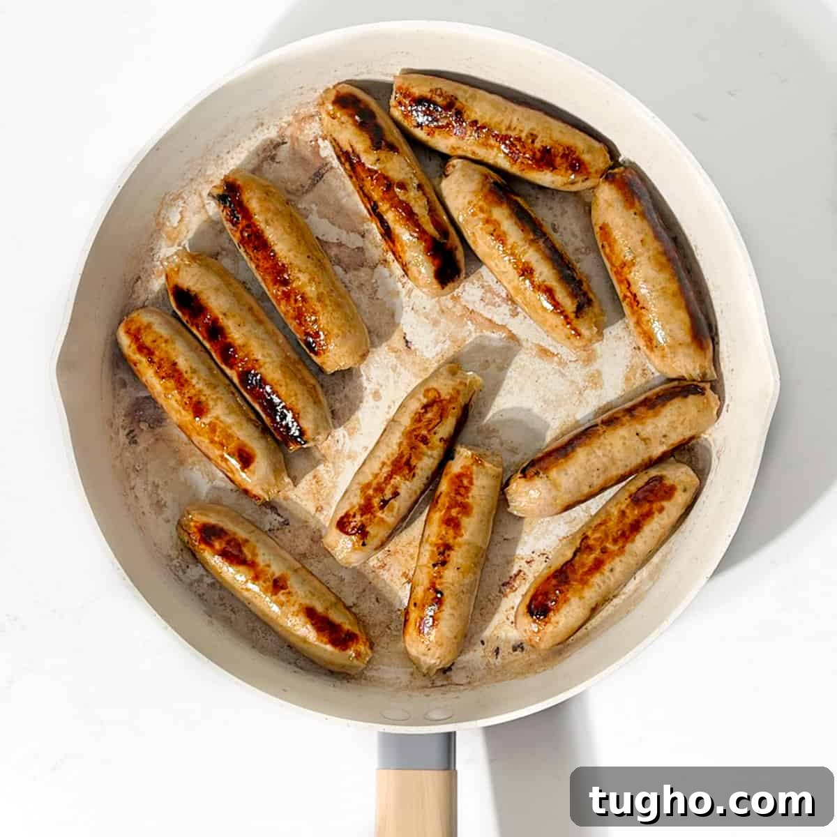 Devilled Sausages Recipe with Tangy Tomato Glaze 7 Frying the sausages in a large pan.