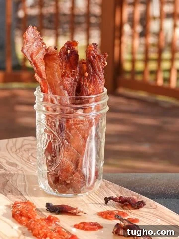 chicken jerky in jar on cutting board