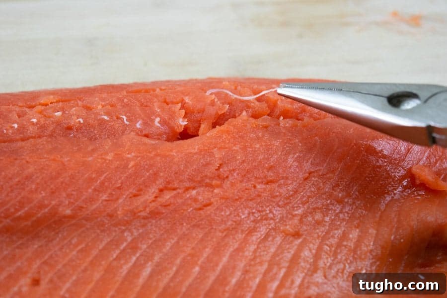 Removing pin bones from salmon filet