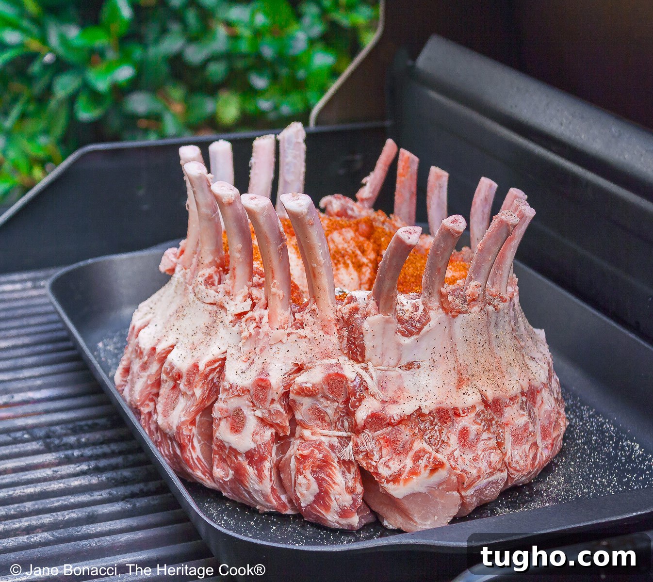 Raw crown pork roast on the grill. 