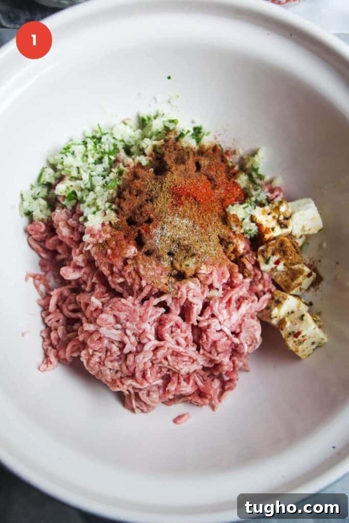 Ground lamb with spices in a large mixing bowl.