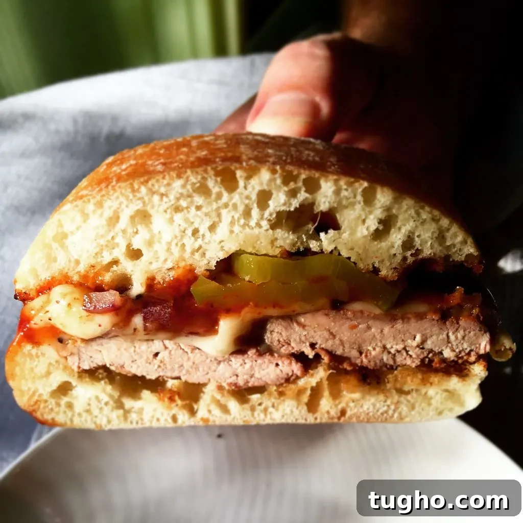 Grilled Pork Tenderloin Sandwich Recipe 3 Grilled Pork Tenderloin Sandwich, holding sandwich to show filling