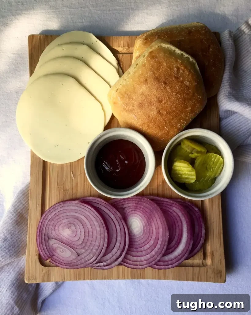 Grilled Pork Tenderloin Sandwich Recipe 5 Grilled Pork Tenderloin Sandwiches, toppings and buns on cutting board