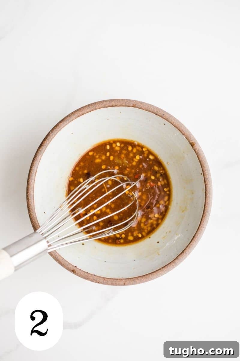 Homemade Gluten-Free Stir-Fry Sauce Recipe 5 A bowl with tamari with chili flakes.