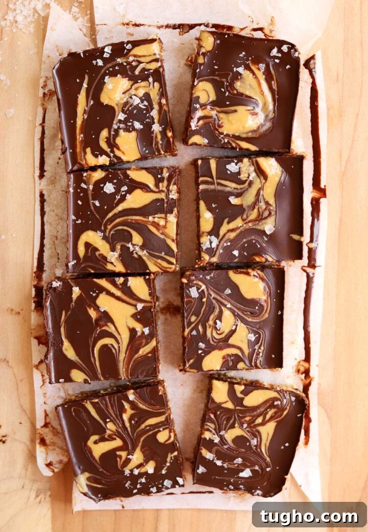 no bake chocolate tahini date oat bars sliced on cutting board