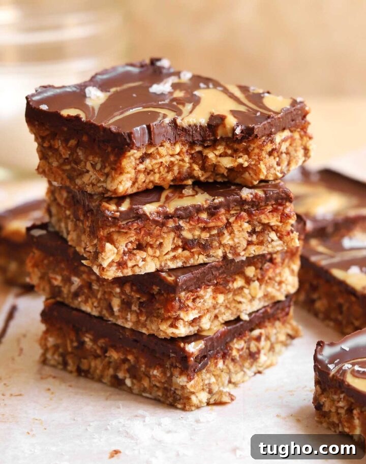 no bake chocolate tahini date oat bars stacked with bite