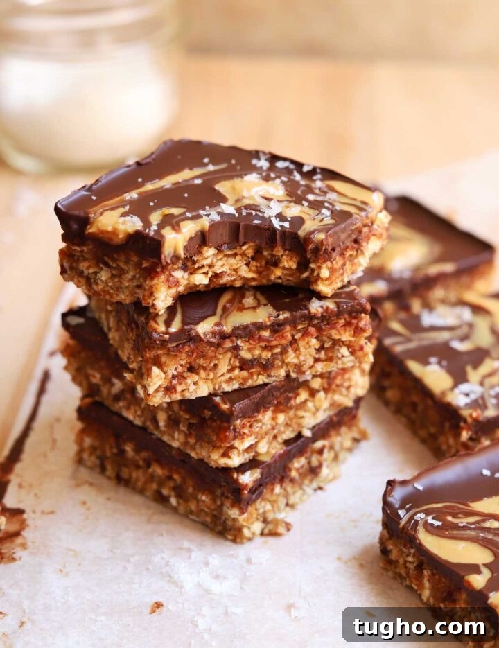 stacked no bake chocolate tahini date oat bars with bite