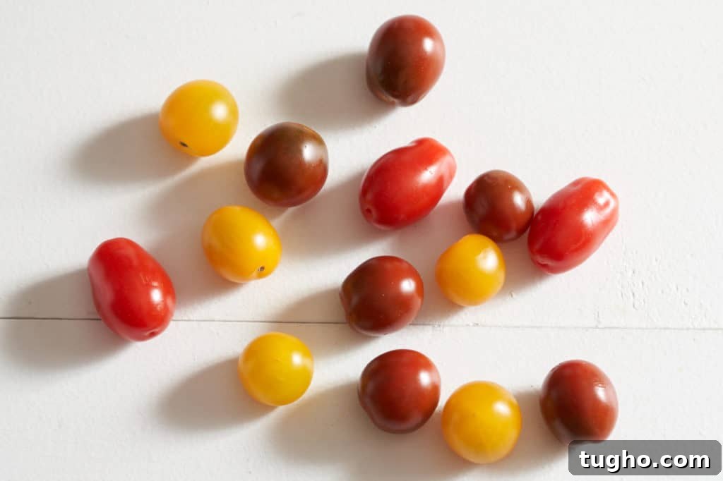 Cherry tomatoes in various shades of red and yellow.