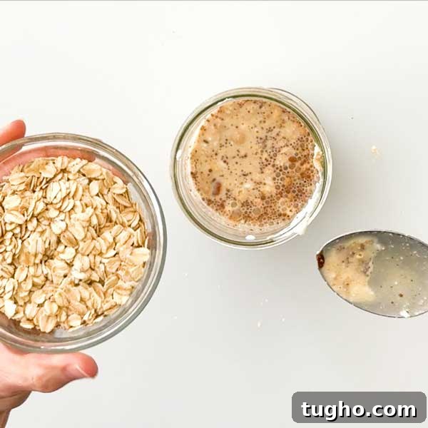 Gingerbread Overnight Oats with High-Protein Greek Yogurt 5 Adding the oats to the mason jar with all the ingredients.