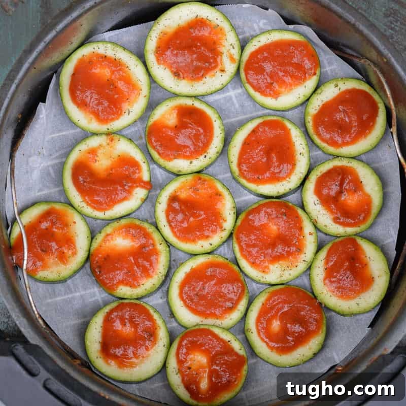 Zucchini slices topped with marinara for pizza bites