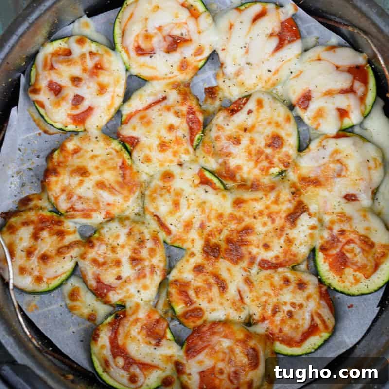 Cooked air fryer zucchini pizza bites with melted cheese