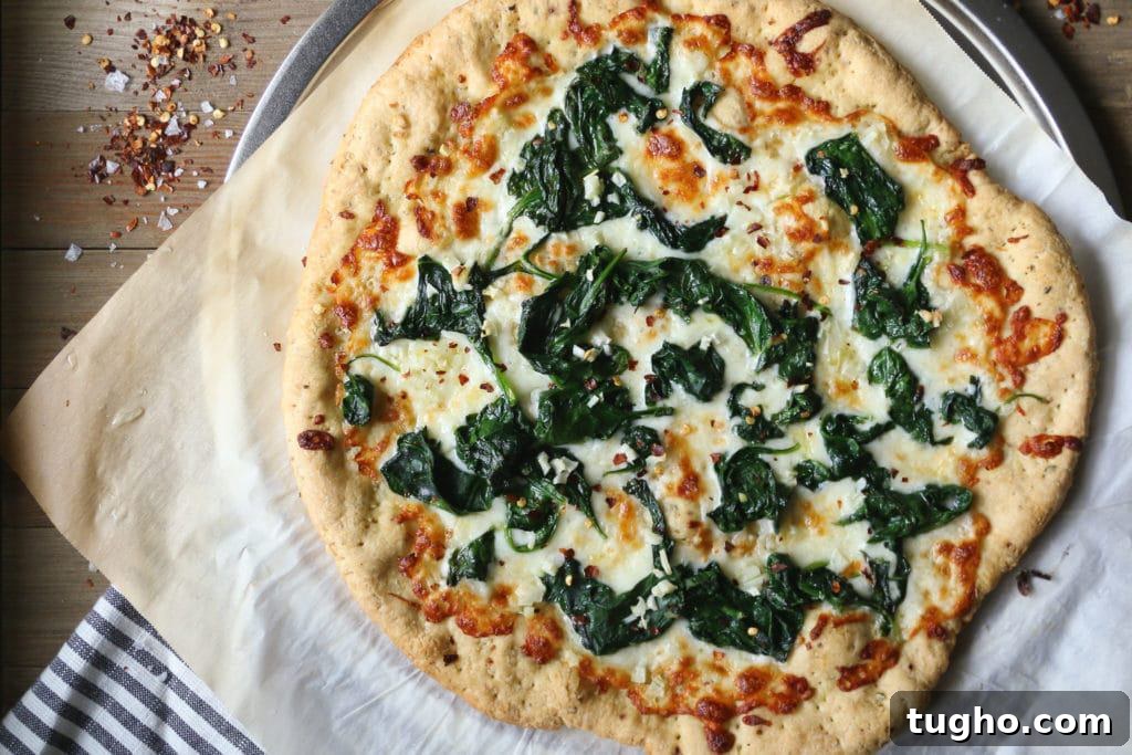 Spinach Garlic White Pizza 3 Pizza with Spinach and Garlic on Parchment paper