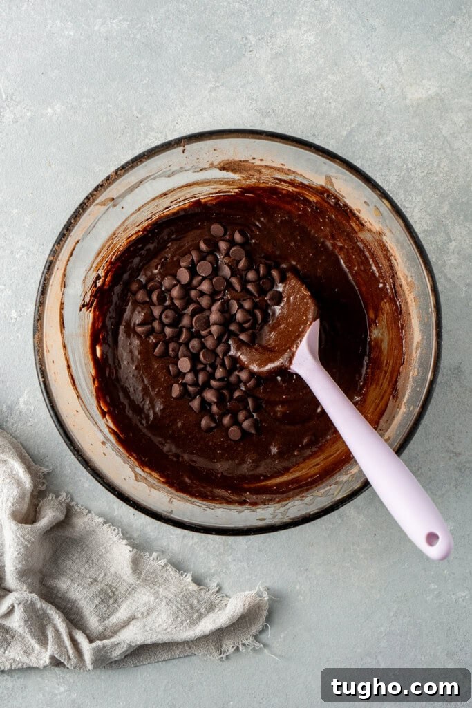 Fudgy Dairy-Free Chocolate Brownies 5 Mixing together the brownie batter in a glass bowl.