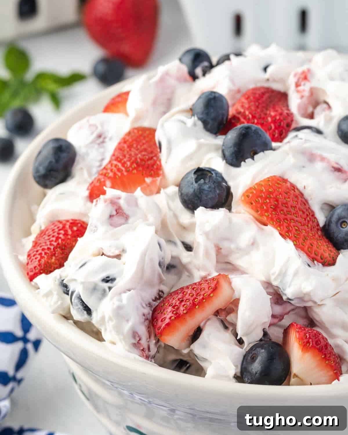 Patriotic Red, White and Blue Cheesecake Salad Recipe 2 Red, white, and blue cheesecake salad filled with strawberries and blueberries.