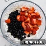 Patriotic Red, White and Blue Cheesecake Salad Recipe 7 Blueberries and strawberries added to cheesecake mixture.