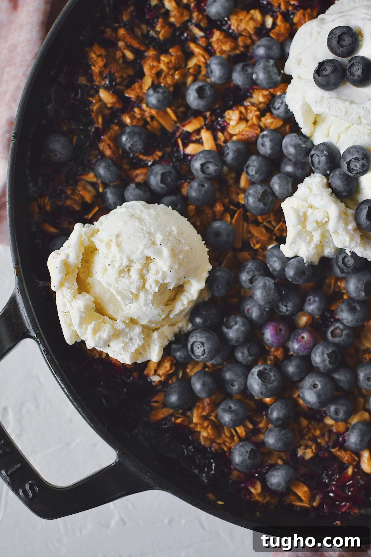 Blueberry Rhubarb Crisp Recipe with Oat Streusel 11 Crisp fresh from the oven with vanilla ice cream on top and extra blueberries.
