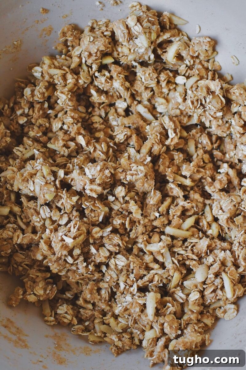 Blueberry Rhubarb Crisp Recipe with Oat Streusel 7 Butter, brown sugar, cinnamon, ginger, salt, and slivered almonds in a large bowl after mixing the crisp topping.