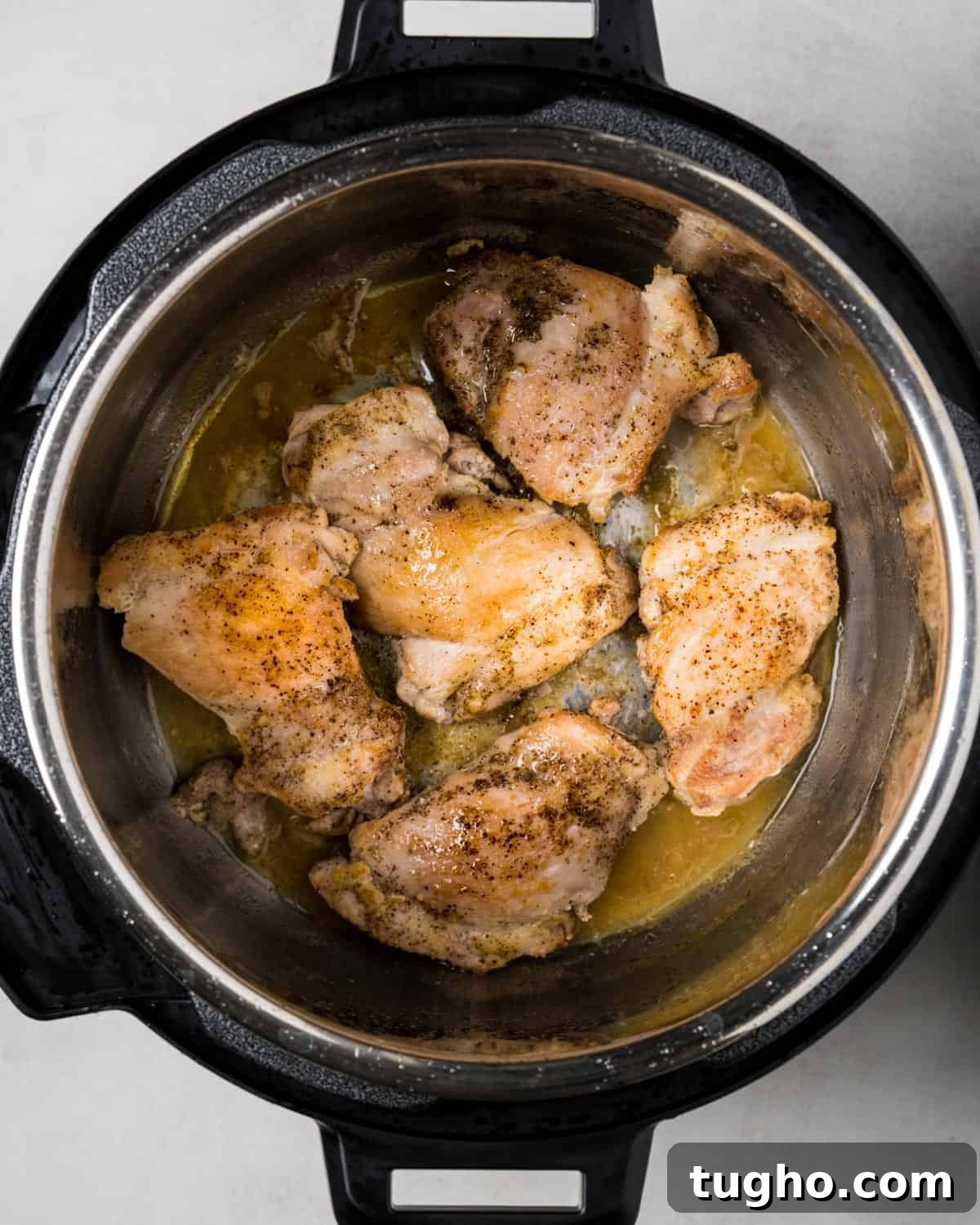 Instant Pot Chicken Stew with Tender Vegetables 5 Sautéing chicken thighs in instant pot.