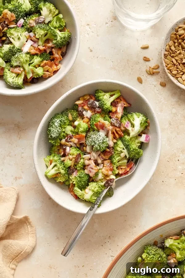 Dairy-Free Broccoli Salad Recipe with Cranberries and Almonds 5 Dairy Free Broccoli Salad with Bacon in several small white bowls.