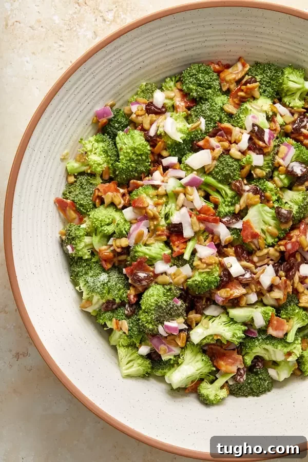Dairy-Free Broccoli Salad Recipe with Cranberries and Almonds 6 Close up view of Dairy-Free Broccoli Salad in a serving bowl.