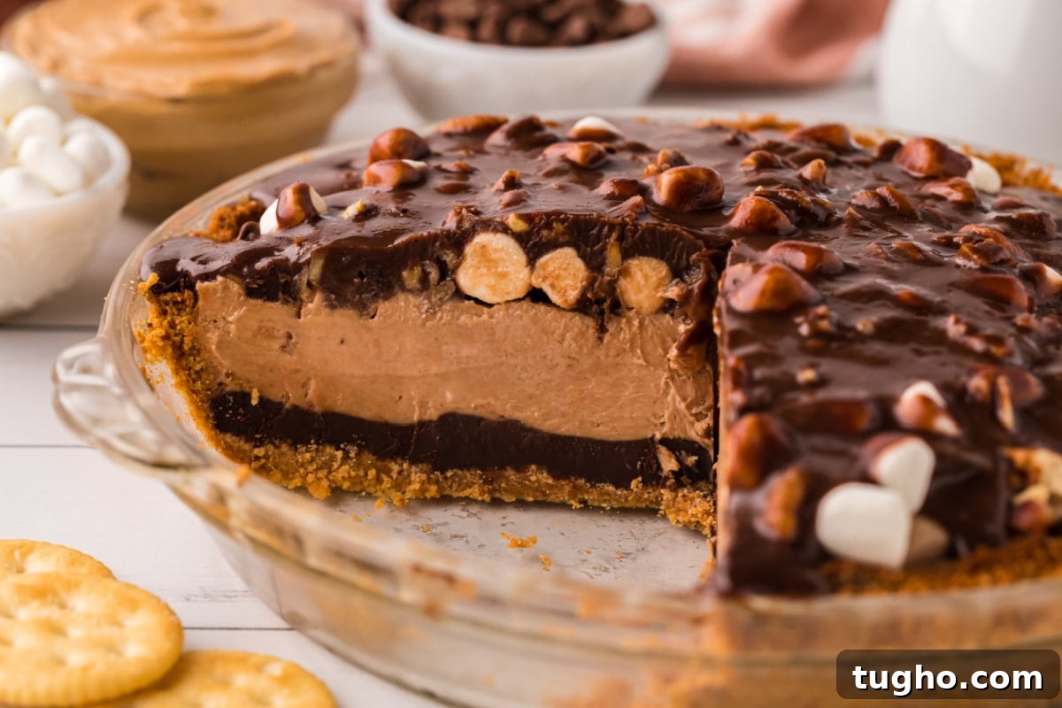 Authentic Texas Flood Pie Recipe 5 A side view of the pie with a slice removed to show layers of chocolate and peanut butter.