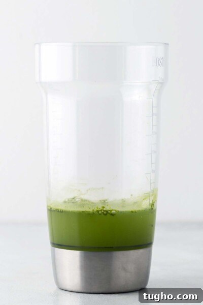 Layered Matcha Lemonade Recipe: Iced Citrus Green Tea 5 Water and matcha in a cocktail shaker.
