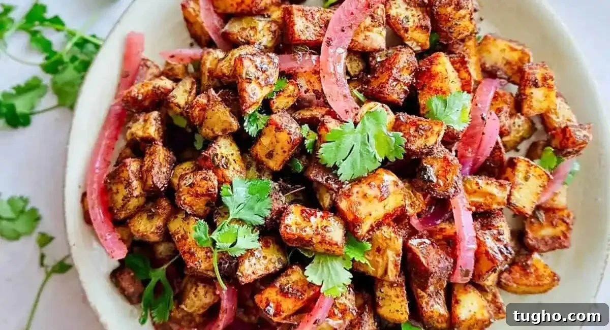Overhead image of roasted Mexican potatoes with garnish. 