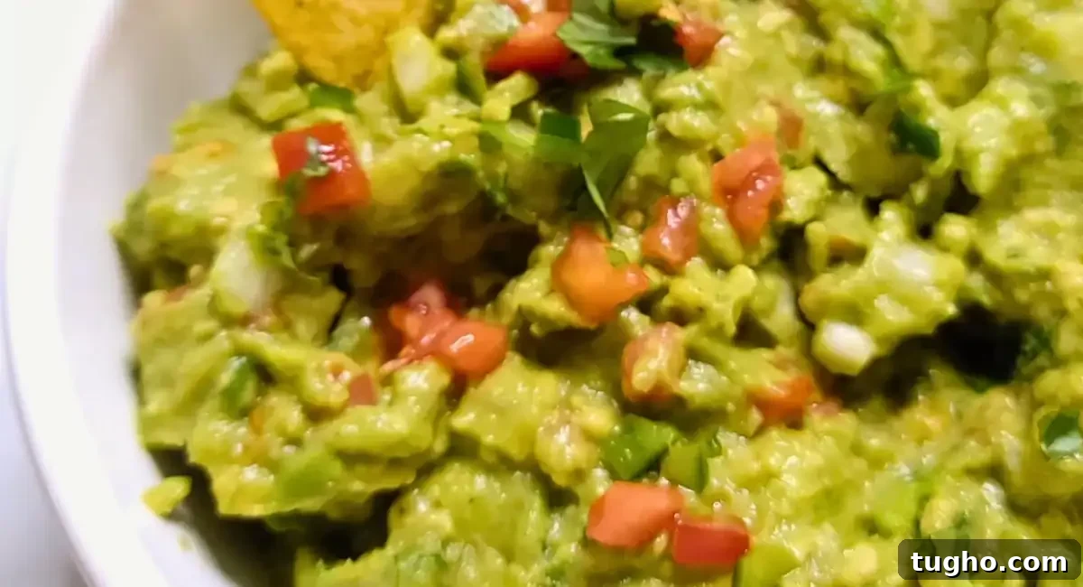 Overhead up close image of guacamole in white dish. 