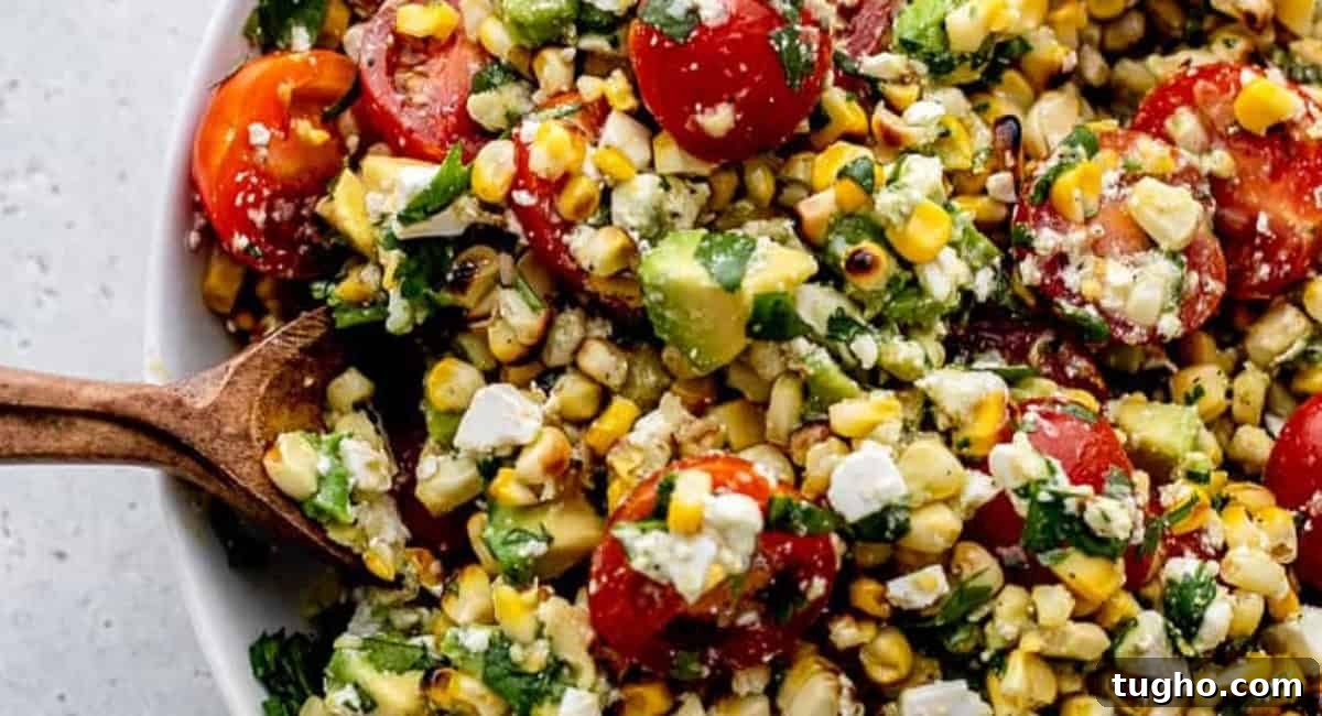 Overhead up close image of grilled corn avocado salad with cilantro lime dressing. 