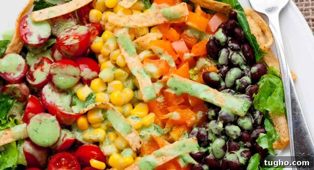 Overhead up close image of southwest chopped salad on white plate with fork. 