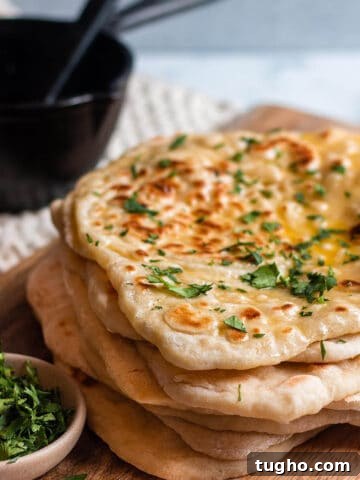 Zesty Sourdough Lemon and Poppy Seed Muffins 8 stack of sourdough naan on a wood board with cilantro