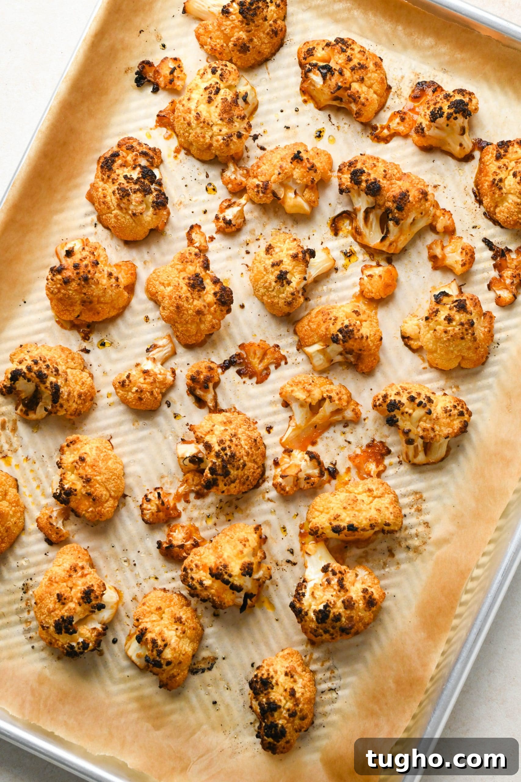 Roasted Buffalo Cauliflower Recipe (Dairy-Free) 11 How to make buffalo cauliflower: Roasted cauliflower florets tossed with buffalo sauce and spread out on sheet pan after roasting a second time.