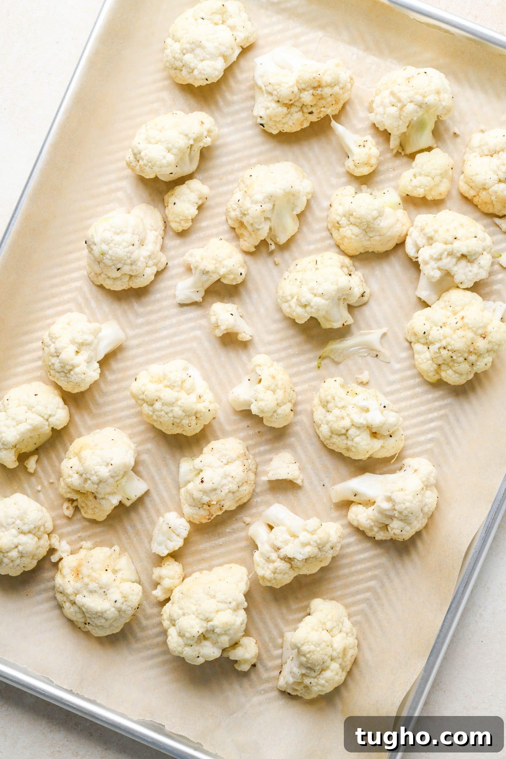 Roasted Buffalo Cauliflower Recipe (Dairy-Free) 7 How to make buffalo cauliflower: Raw cauliflower florets on a sheet pan before roasting.