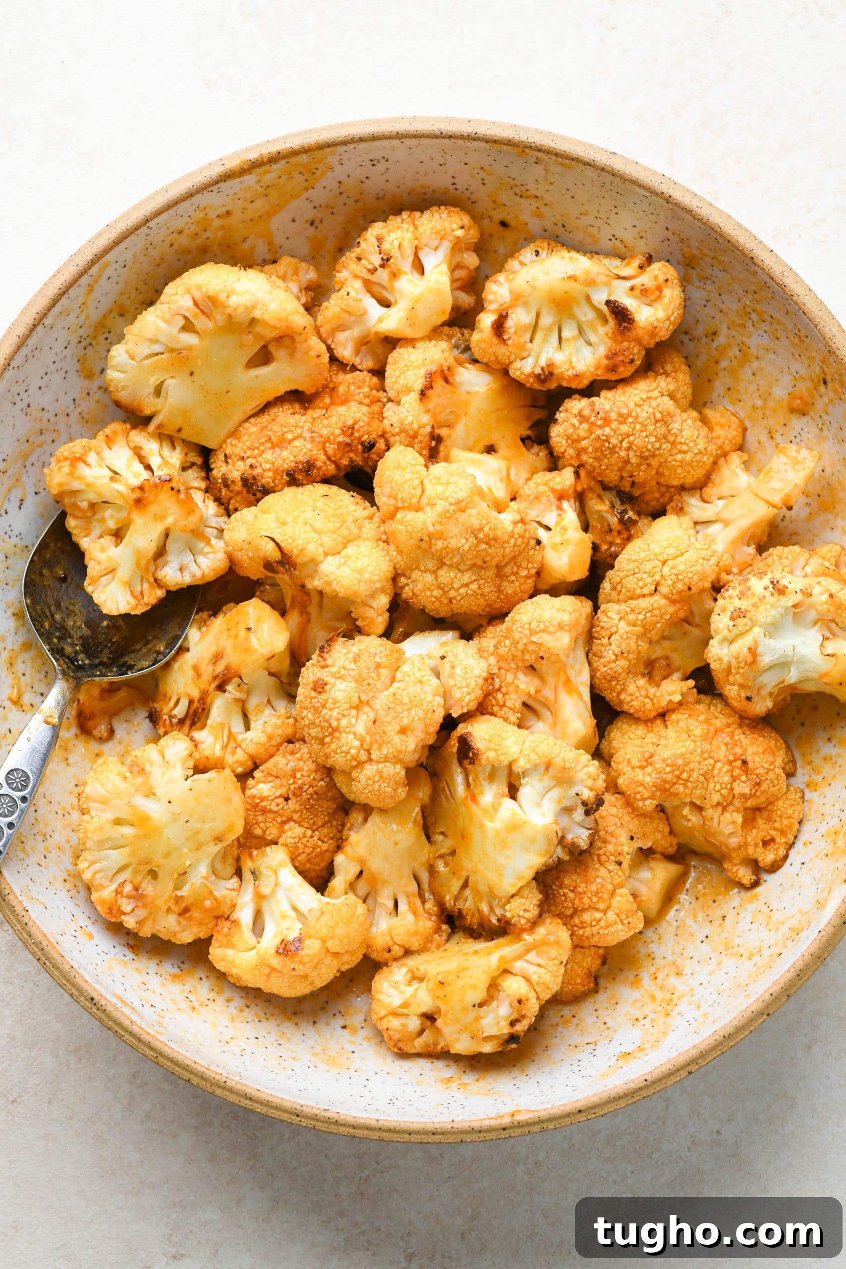 Roasted Buffalo Cauliflower Recipe (Dairy-Free) 9 How to make buffalo cauliflower: Roasted cauliflower florets in a bowl tossed with buffalo sauce.