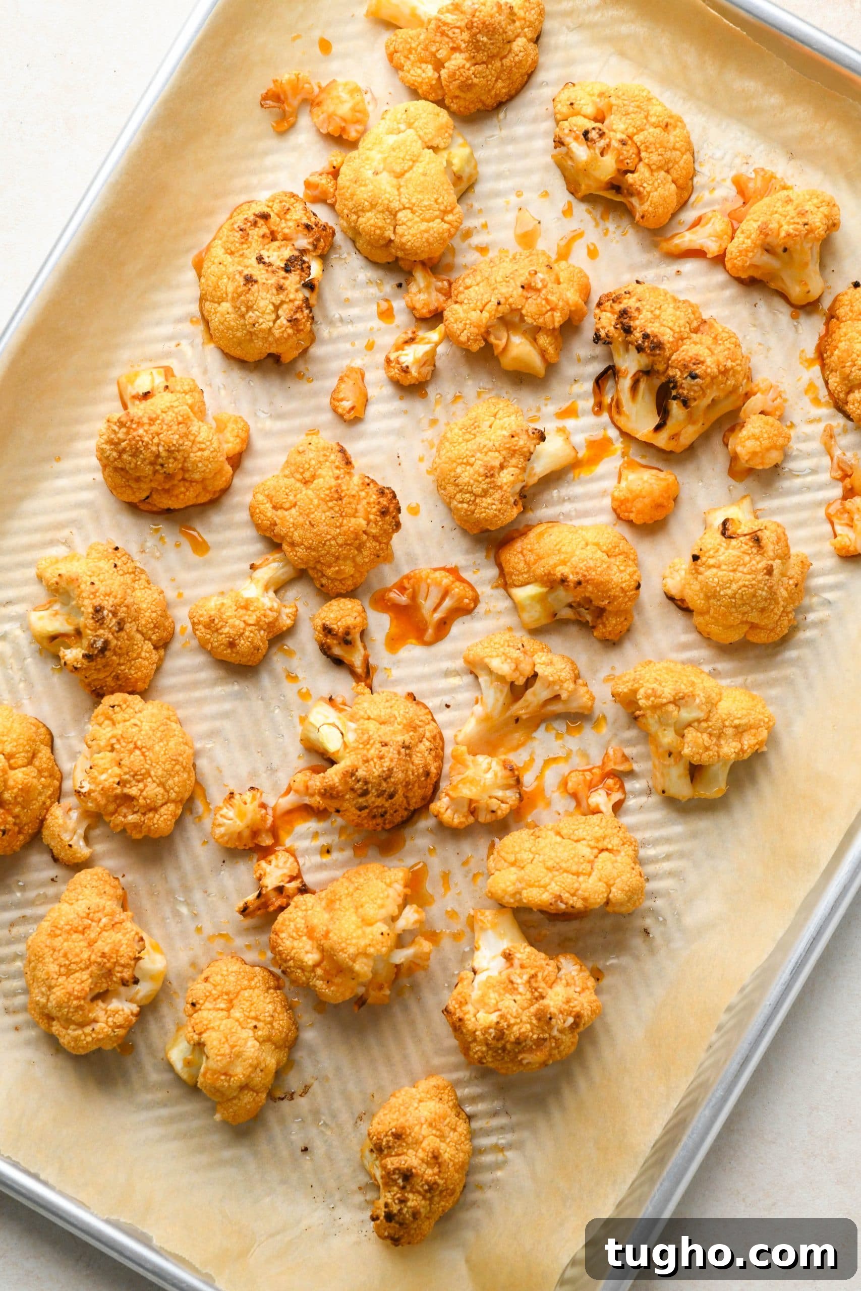 Roasted Buffalo Cauliflower Recipe (Dairy-Free) 10 How to make buffalo cauliflower: Roasted cauliflower florets tossed with buffalo sauce and spread out on sheet pan.