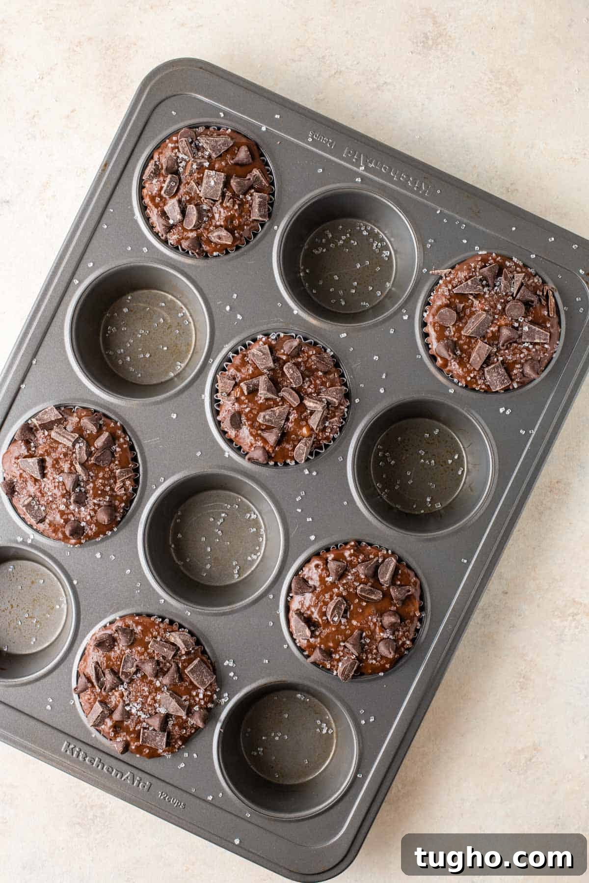 every other hole in muffin pan filled with chocolate batter