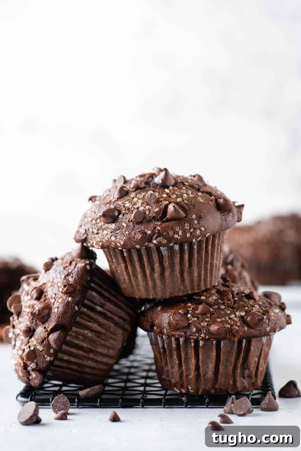 chocolate muffins stacked on black wire rack