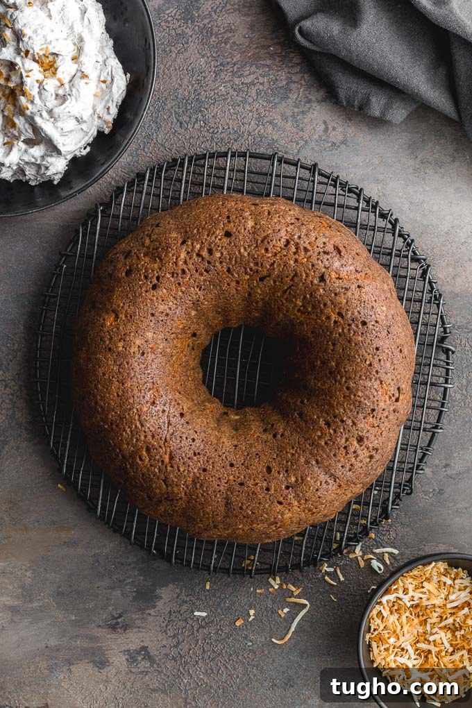 Dairy-Free, Eggless Coconut Carrot Cake Recipe 6 Coconut carrot cake cooling on a round wire rack.