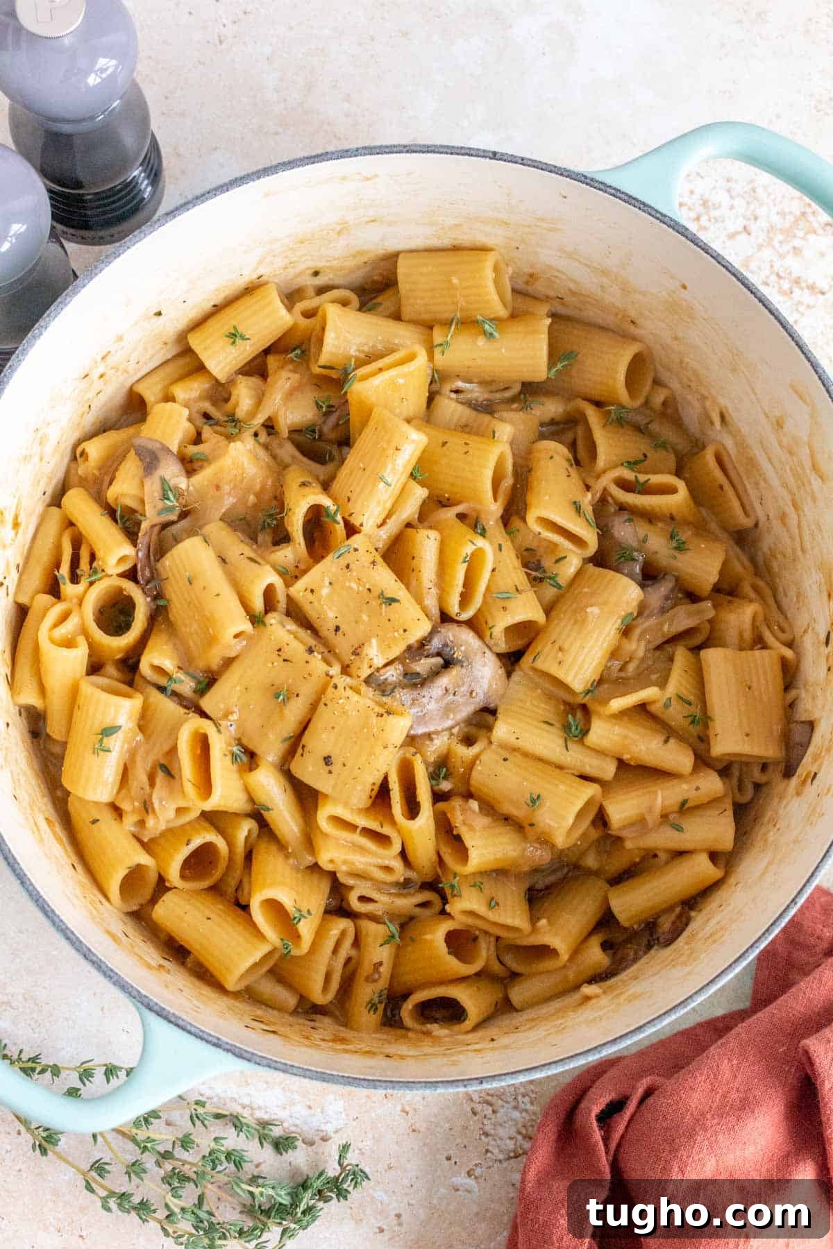 Creamy One-Pot French Onion Pasta 7 Overhead view of an one pot french onion pasta topped with fresh thyme as garnish.