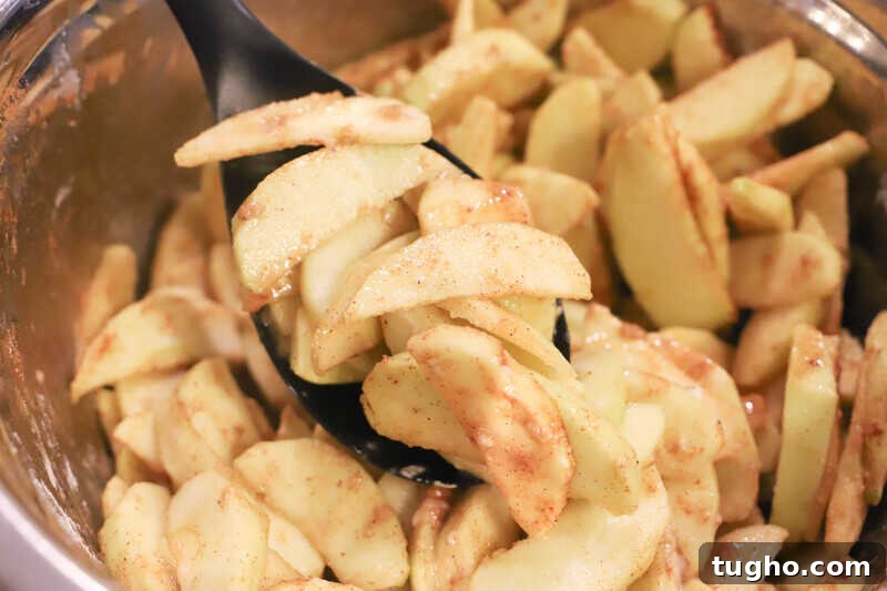 Caramel Dutch Apple Pie Recipe 3 sliced apples in a bowl